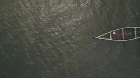 Floating canoe, abandoned and half-filled with water, on lake Victoria Stock Footage 230080253
