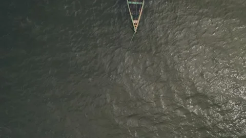 Floating canoe, abandoned and half-filled with water, on lake Victoria Stock Footage 230080254