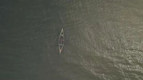 Floating canoe, abandoned and half-filled with water, on lake Victoria Stock Footage 230080282
