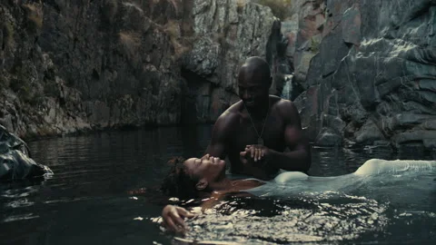 Floating in a ceremony pool, enjoying peaceful moments near the cliffs Stock Footage 319906861