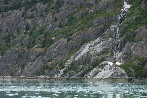 Floating chunks of in front of falling water and geologic structures at End.. Stock Photos