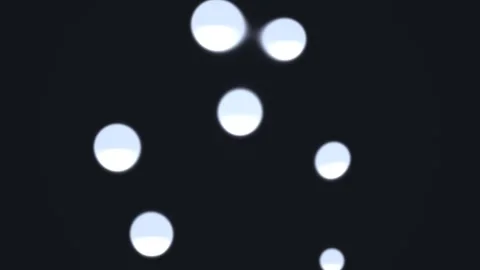Floating circles create a graphic design against a dark Stock Footage 338317455
