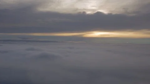 Floating in the clouds: Aerial view of the sun setting between the clouds high Stock Footage 101302593