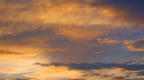 Floating clouds, illuminated orange by the setting sun Stock Footage 47924284