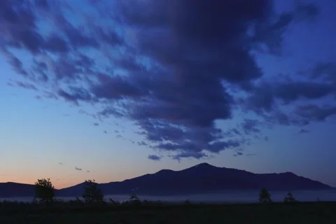 Floating clouds in the mountains at sunset Stock Footage 157795966