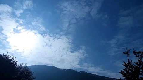 Floating clouds in the sky in day time over village area Tehri Uttarakhand Stock Footage 103579086