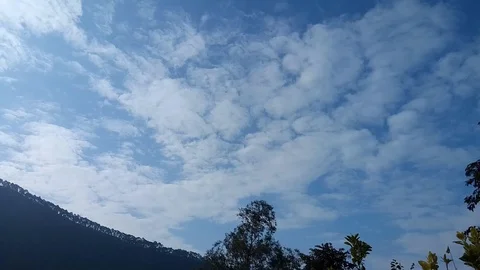 Floating clouds in the sky in day time over village area Tehri Uttarakhand Stock Footage 103928001
