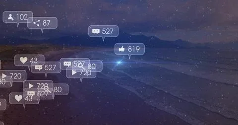 Floating cluster of notification bubbles glowing on sandy shore at night, Stock Photos