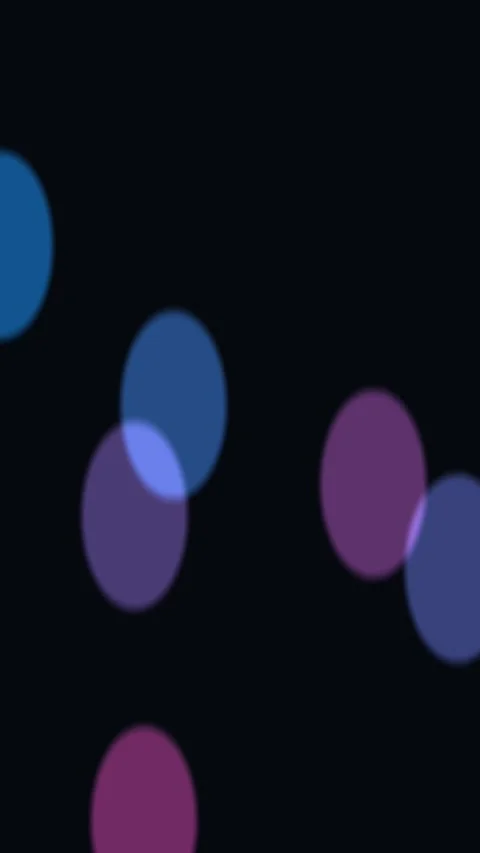 Floating colored circles drift across a black field Video stock 329290823
