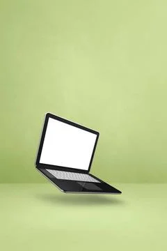 Floating computer laptop isolated on green. Vertical background Blank comp... Stock Photos