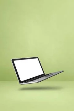 Floating computer laptop isolated on green. Vertical background Blank comp... Stock-Fotos