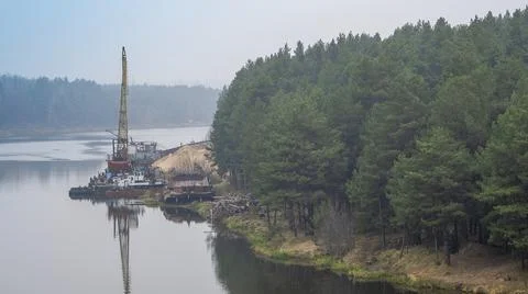 Floating crane on the river. Dredging crane working near shore. Conservation  Stock Photos