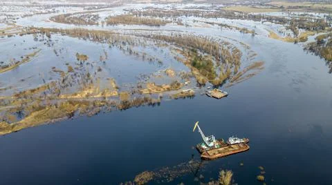 Floating crane on the river. Dredging crane working near shore. Conservation  Stock Photos