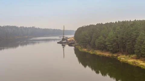 Floating crane on the river. Dredging crane working near shore. Conservation  Stock Photos
