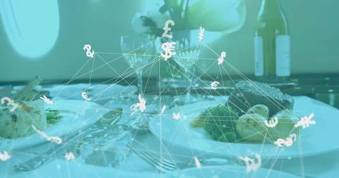 Floating currency network hovering above jet cabin dining table, with gourmet Stock Photos