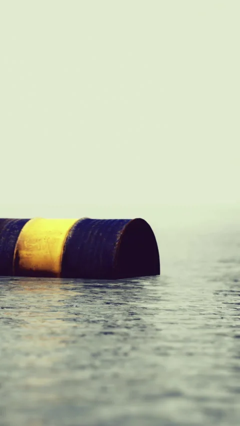 Floating cylindrical object creates contrast on calm water surface at dawn Stock Footage 334256808