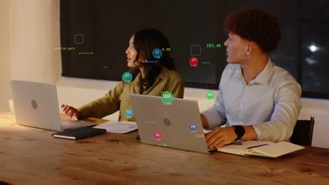 Floating data icons appearing on laptops urging woman and man shifting focus to Stock Footage 332880782