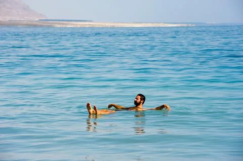Floating in the dead sea Stock Photos