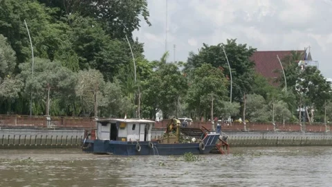 Floating deck POV, debris cleanup vessel cleaning up the Martapura river Stock Footage 156994236