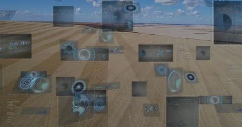 Floating digital panels displaying data and diagrams over arid plain, with map Stock Photos