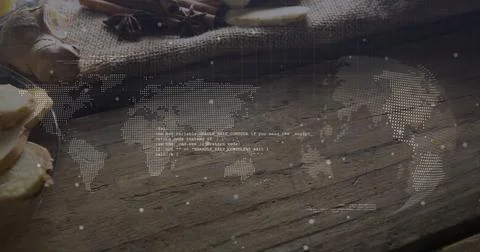 Floating dotted world map with code above pantry counter, showing ginger slices, Stock Photos