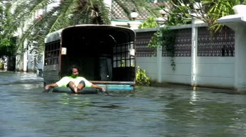 Floating Down A Flooded Street In An Inner Tube 스톡 동영상 8969020