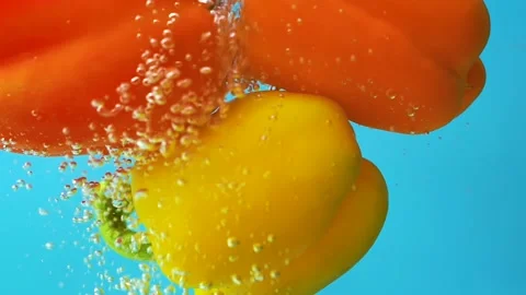Floating down three color sweet bell pepper in clear water and bubbles, close up Stock Footage 157456330