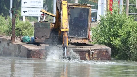 A floating dredger is dredging the bottom of the pond, Thailand Stock Footage 234467165
