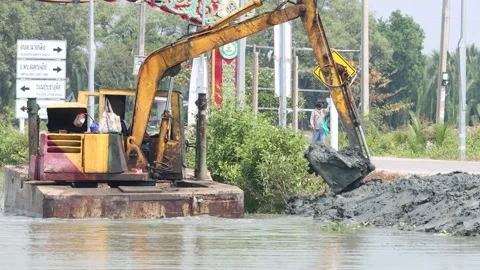 A floating dredger is dredging the bottom of the pond, Thailand Stock Footage 235426930