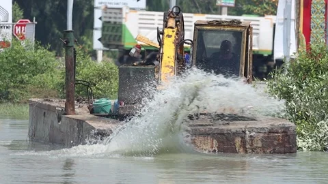 A floating dredger is dredging the bottom of the pond, slow motion Stock Footage 237524606