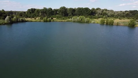 Floating dredgers operating in a flooded sand quarry aerial view industry Stock Footage 211483645