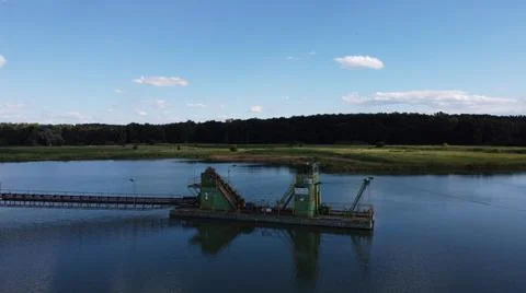 Floating dredgers operating in a flooded sand quarry aerial view industry Stock Photos