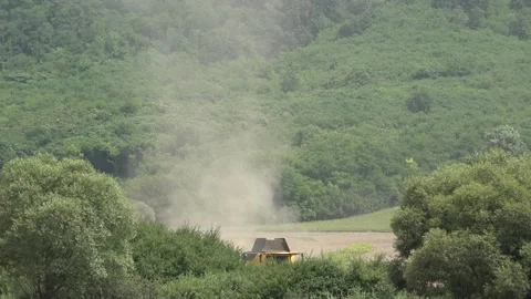 Floating dust over a wheat field and harvest 스톡 동영상 257539749