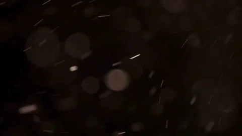 Floating dust particles dance across a dark atmospheric background Stock Footage 329598025