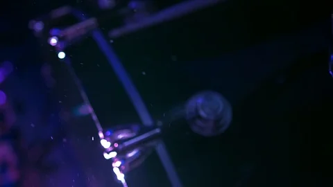 Floating dust specks in light rays, bass drum in darkness at nightclub party Stockbeeldmateriaal 116719638