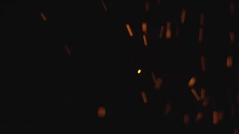 Floating fire sparks rising in darkness against black background. Stock Footage 337532149