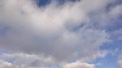 Floating fluffy clouds. Beautiful sunny blue sky with wispy smoky white cumulus Stock Footage 295454863