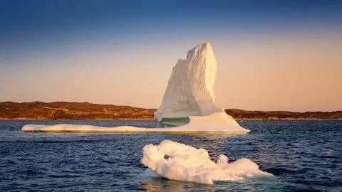 Floating glaciers in the rays of the setting sun at polar night Stock Photos