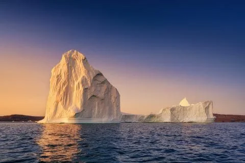 Floating glaciers in the rays of the setting sun at polar night Stock Photos