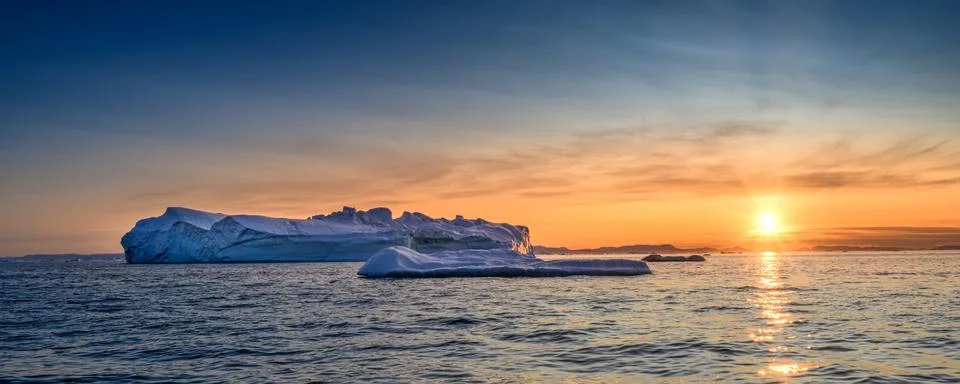 Floating glaciers in the rays of the setting sun at polar night Stock Photos