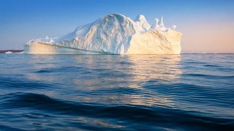 Floating glaciers in the rays of the setting sun at polar night Stock Photos