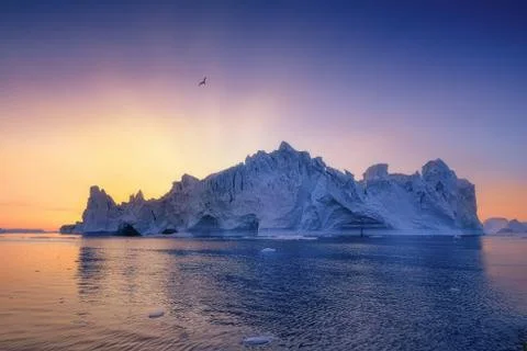Floating glaciers in the rays of the setting sun at polar night Stock Photos