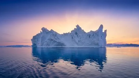 Floating glaciers in the rays of the setting sun at polar night Stock Photos