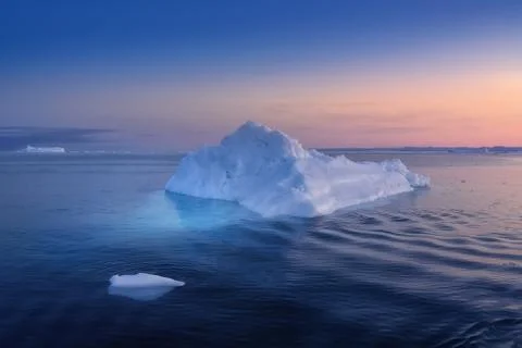 Floating glaciers in the rays of the setting sun at polar night Stock Photos