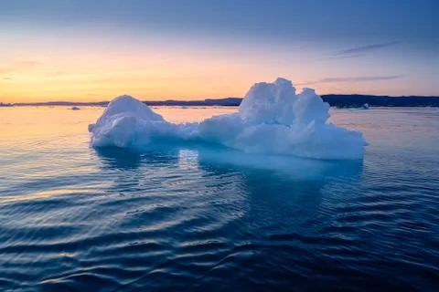 Floating glaciers in the rays of the setting sun at polar night Stock Photos