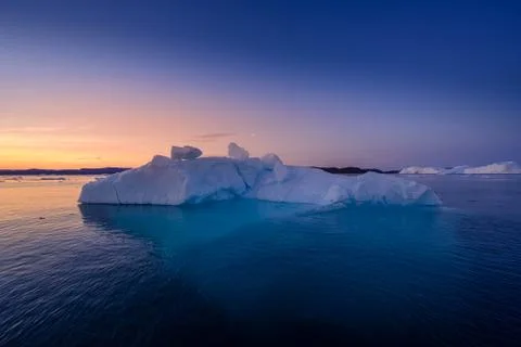 Floating glaciers in the rays of the setting sun at polar night Stock Photos