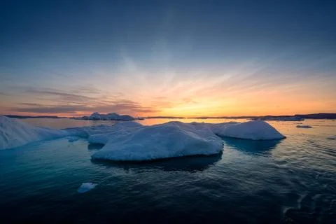 Floating glaciers in the rays of the setting sun at polar night Stock-Fotos