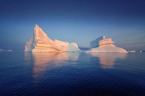 Floating glaciers in the rays of the setting sun at polar night Stock Photos