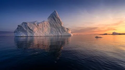 Floating glaciers in the rays of the setting sun at polar night Stock Photos