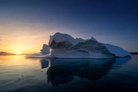 Floating glaciers in the rays of the setting sun at polar night Stock Photos